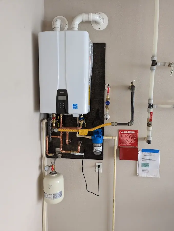 Professional plumber installing copper piping in a Elkland home